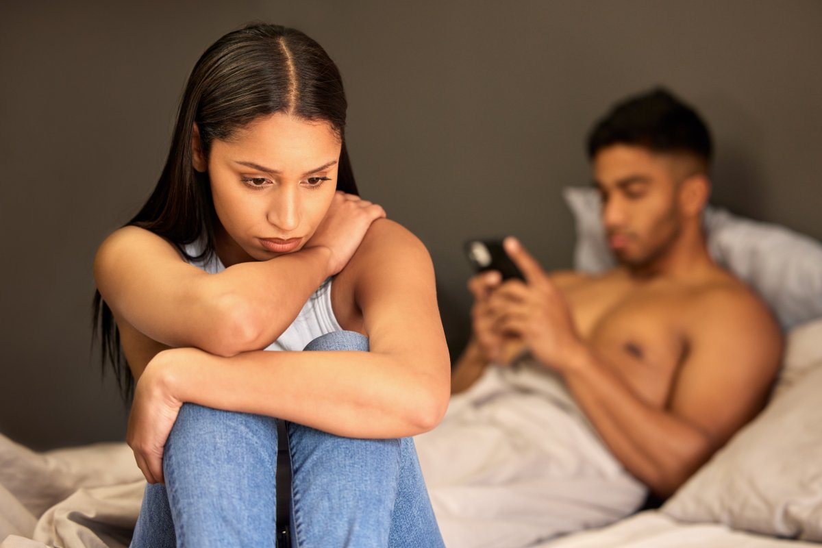 Woman Sits On Edge Of Bed